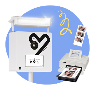 A modern white KRUU Photo Booth against a blue circular background. To the right are printed photo strips and a compact white Selphy printer with printed photos in its tray. A yellow squiggle graphic floats above.